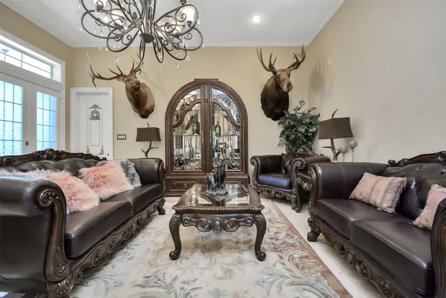 a living room with furniture a fireplace and a chandelier