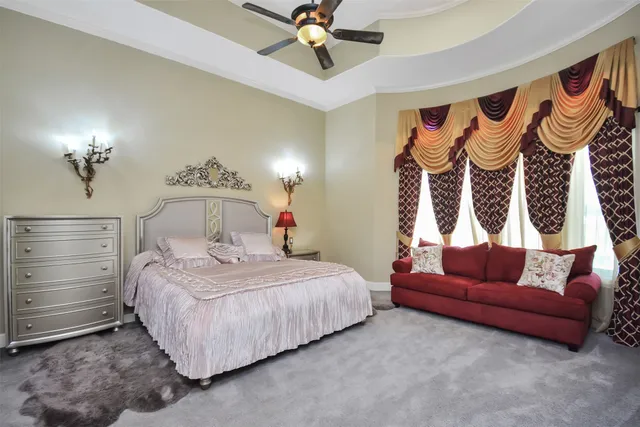 a bedroom with a bed and a chandelier