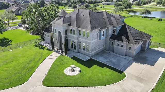 an aerial view of a house with a big yard