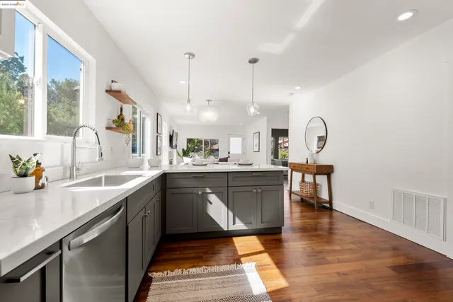 a large kitchen with stainless steel appliances granite countertop a sink counter space and a window