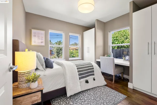 a bedroom with a bed and large window with outer view