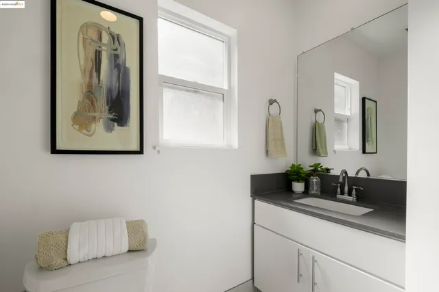 a white toilet sitting next to a bathroom sink
