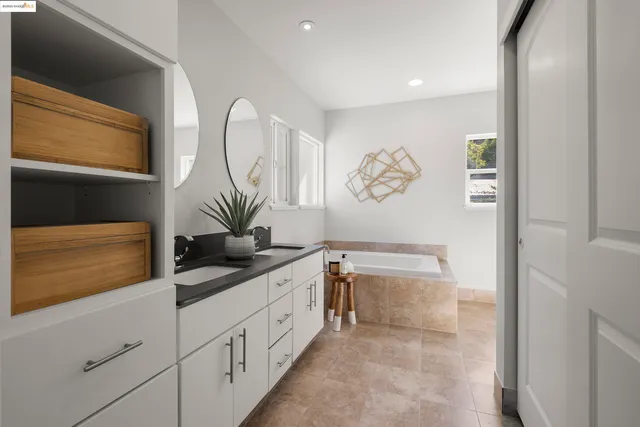 a en suite bathroom with double sink and a mirror