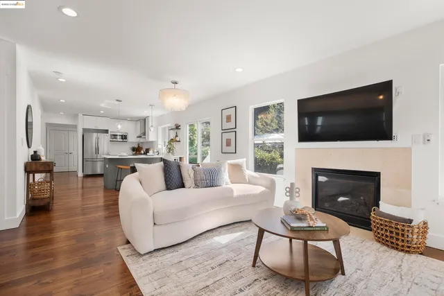 a living room with furniture a fireplace and a flat screen tv