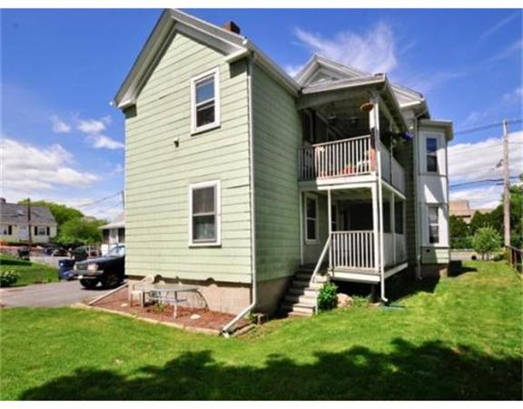 270 Spring Street Boston, MA 02132 - Photo 2 of 18 a view of a house with a yard and sitting area