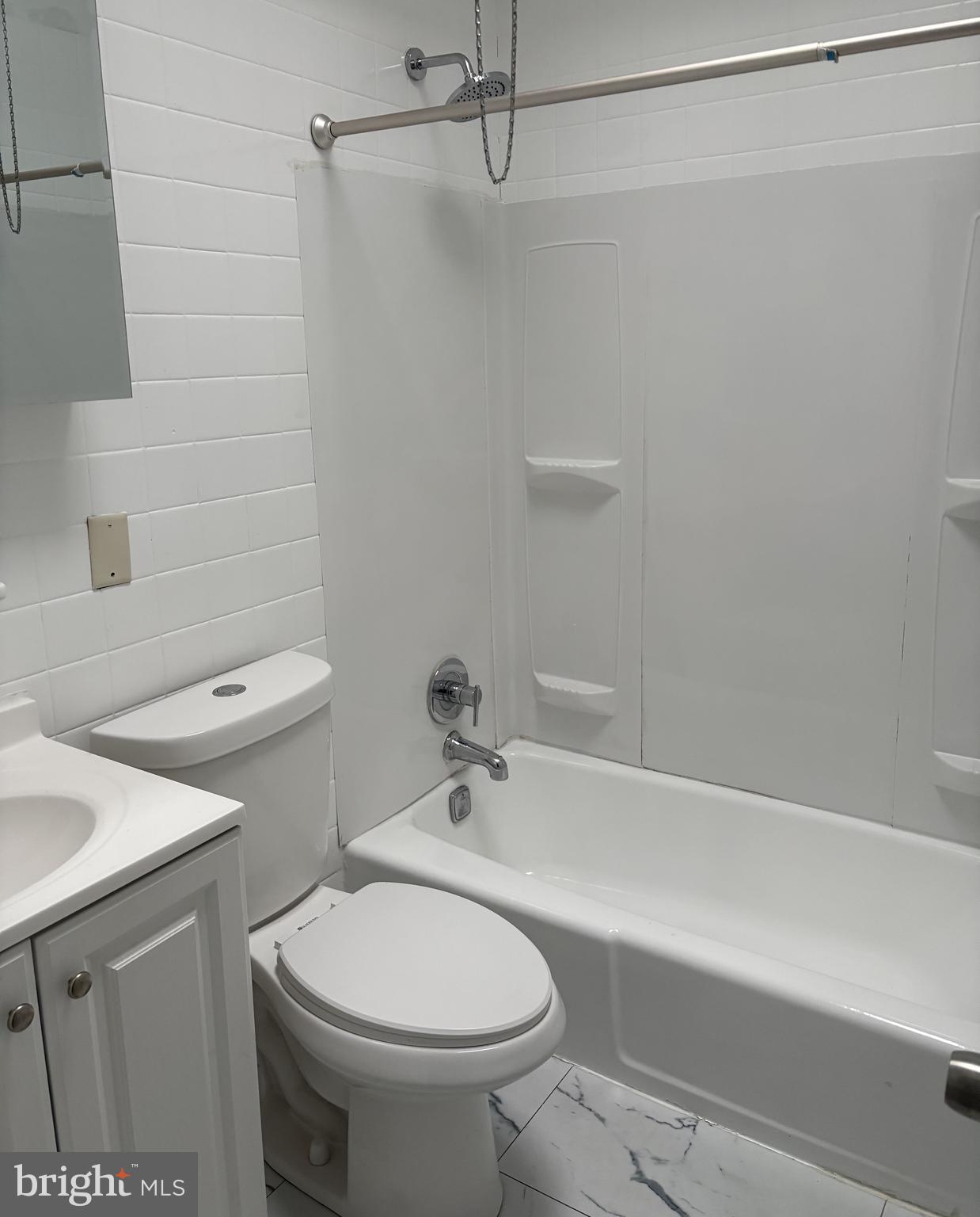 6380 Marsden Street Philadelphia, PA 19135 - Photo 7 of 9 a bathroom with a sink a toilet and shower