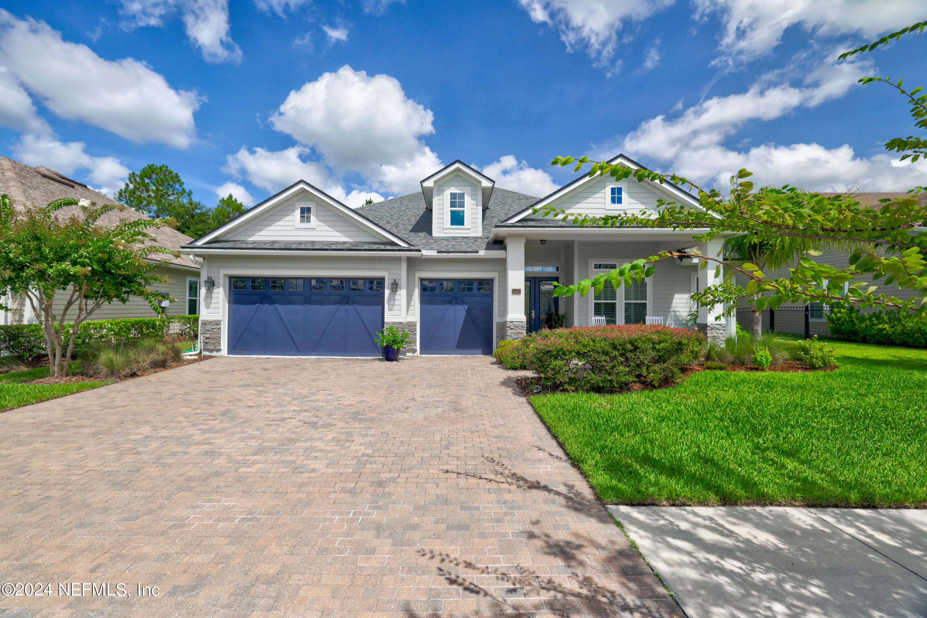 a front view of house with yard and green space