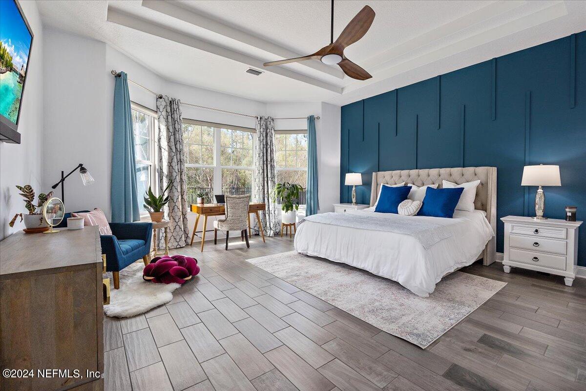 447 Glenneyre Circle St. Augustine, FL 32092 - Photo 12 of 44 a bedroom with a bed a large window with table and chairs