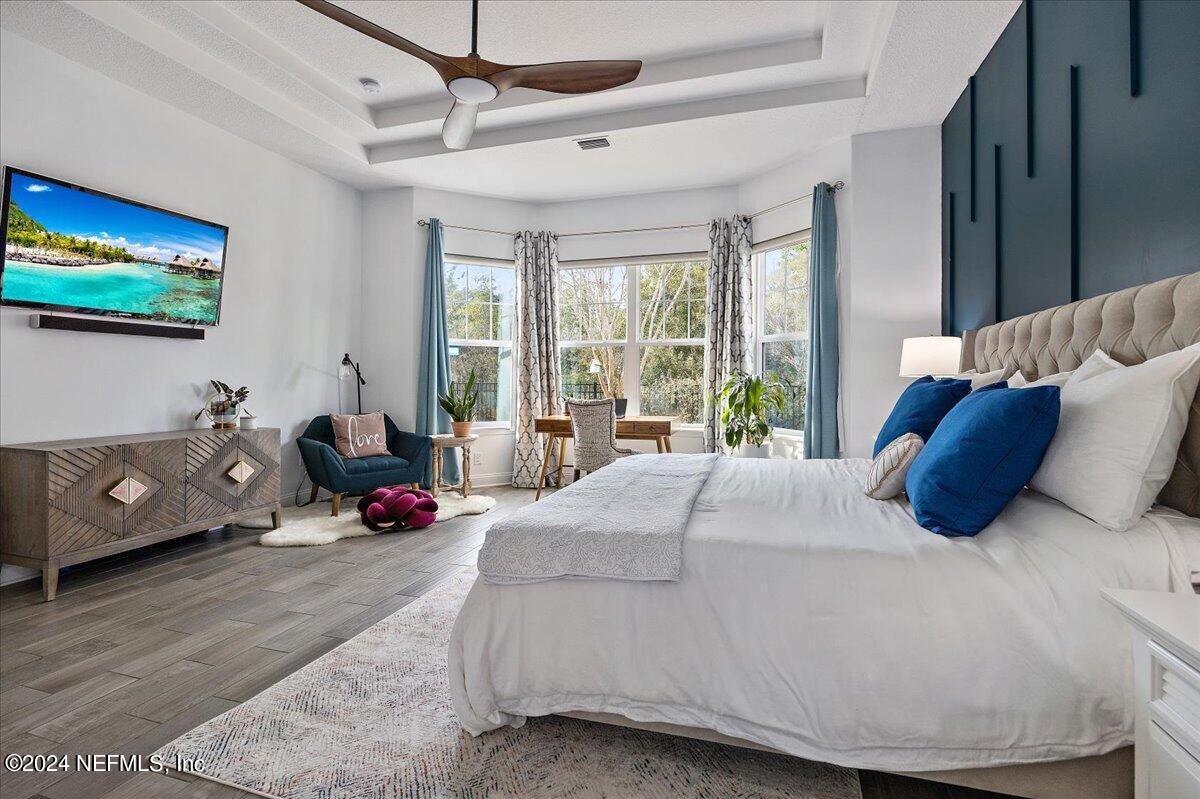 447 Glenneyre Circle St. Augustine, FL 32092 - Photo 13 of 44 a bedroom with a bed and large windows