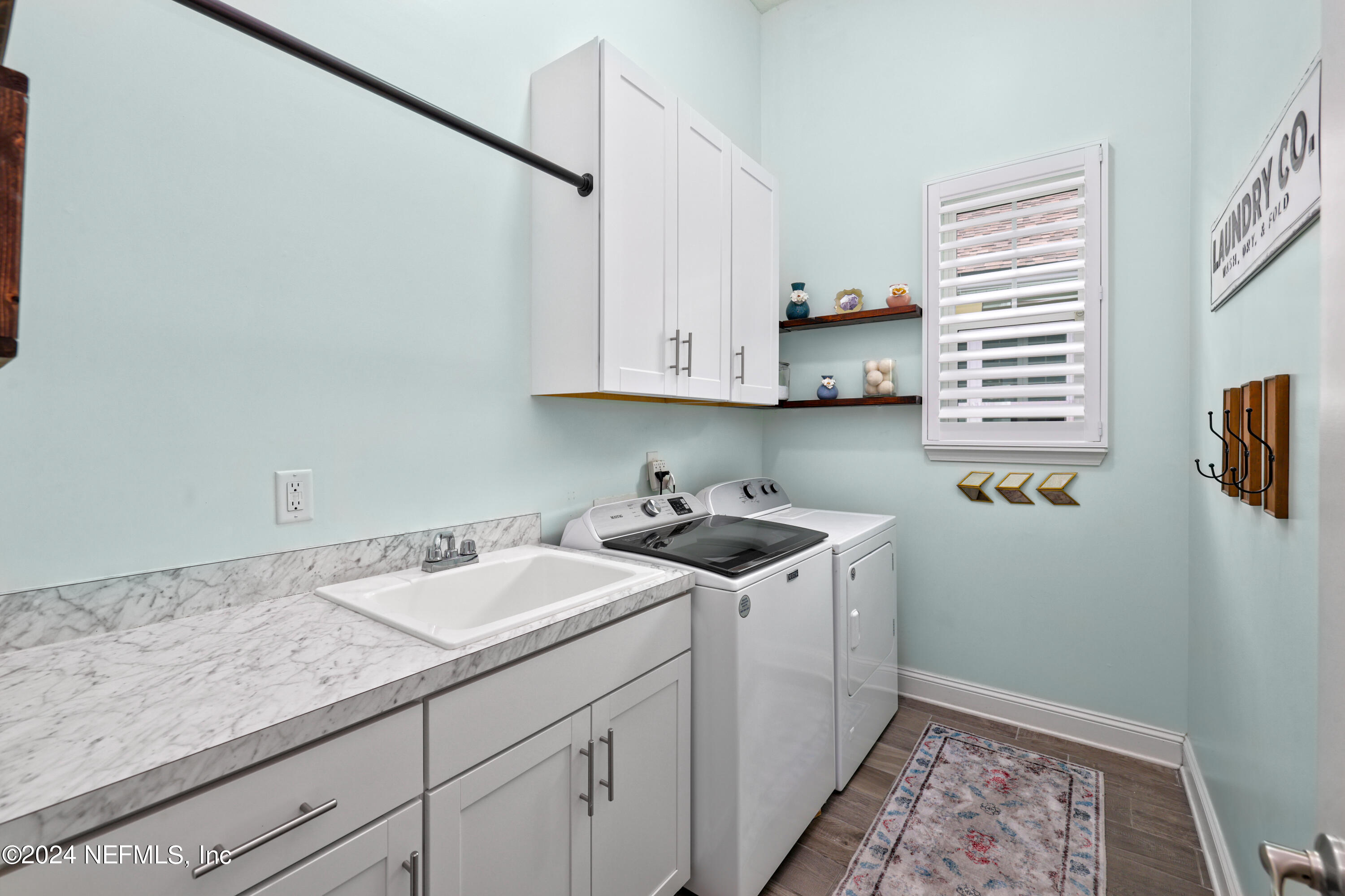 447 Glenneyre Circle St. Augustine, FL 32092 - Photo 21 of 44 a view of a sink and dishwasher with wooden floor