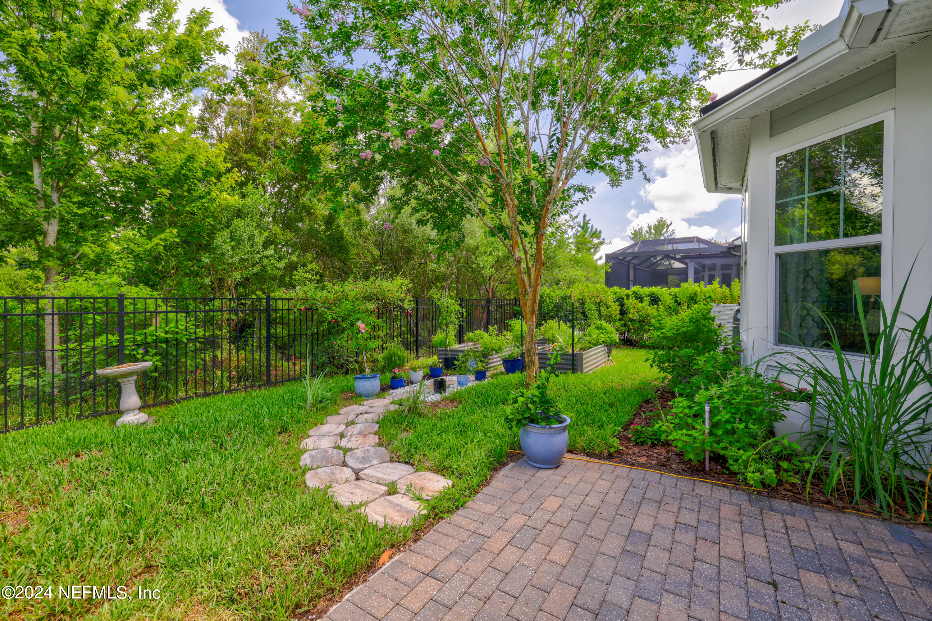 447 Glenneyre Circle St. Augustine, FL 32092 - Photo 29 of 44 a view of a garden with a plants and large trees