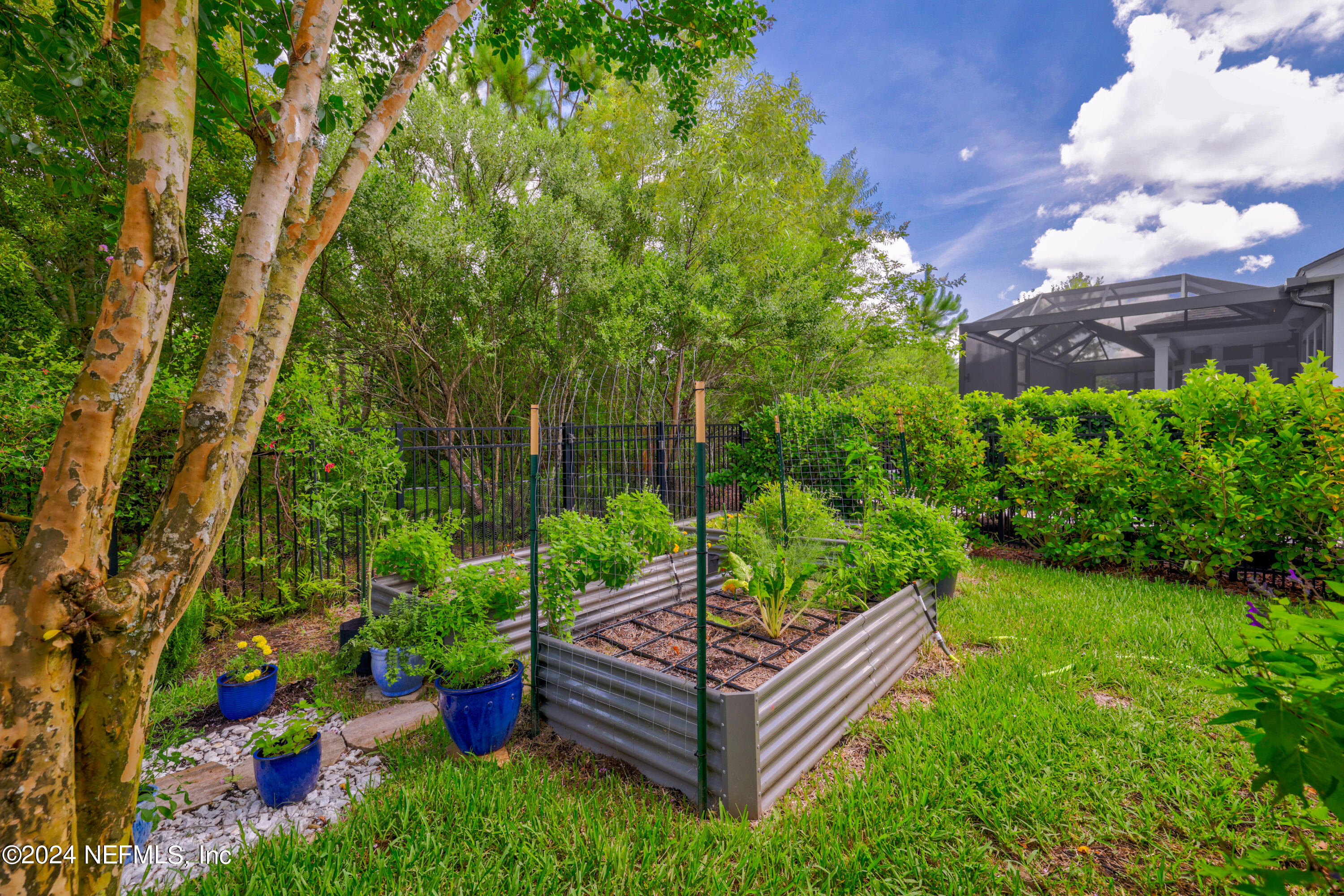 447 Glenneyre Circle St. Augustine, FL 32092 - Photo 32 of 44 a view of a chair and table in the garden