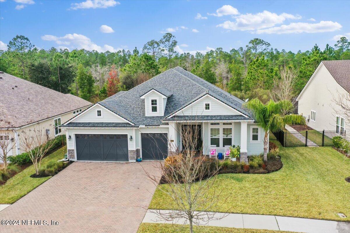 447 Glenneyre Circle St. Augustine, FL 32092 - Photo 43 of 44 a view of a white house with a big yard and potted plants