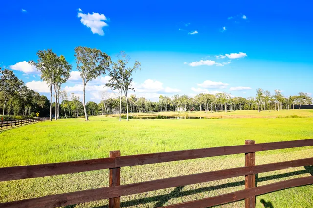 an aerial view of a residential houses with outdoor space
