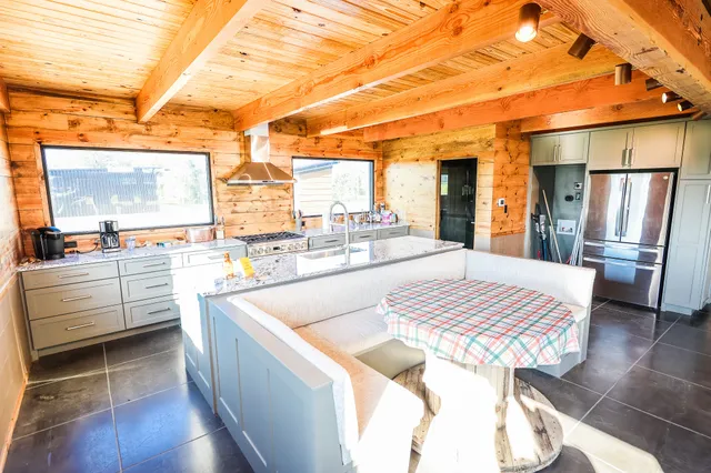 a large white kitchen with a large window