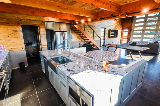 a kitchen with granite countertop a stove and a sink