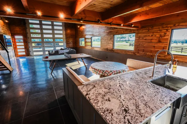 a bathroom with a granite countertop sink a toilet and shower