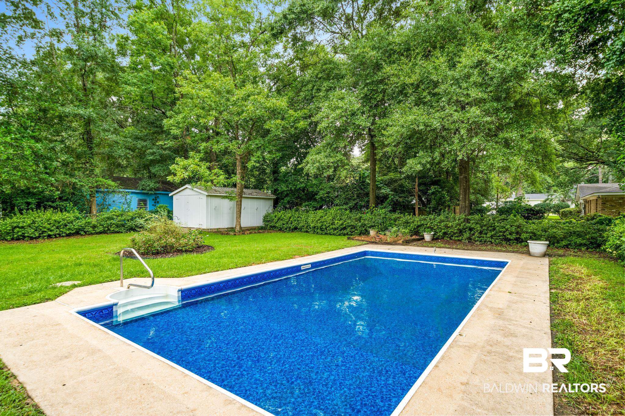 280 Thrift Street Mobile, AL 36609 - Photo 18 of 22 View of pool featuring a shed and a yard
