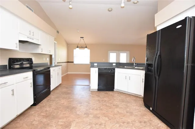 a kitchen with stainless steel appliances a refrigerator sink and stove