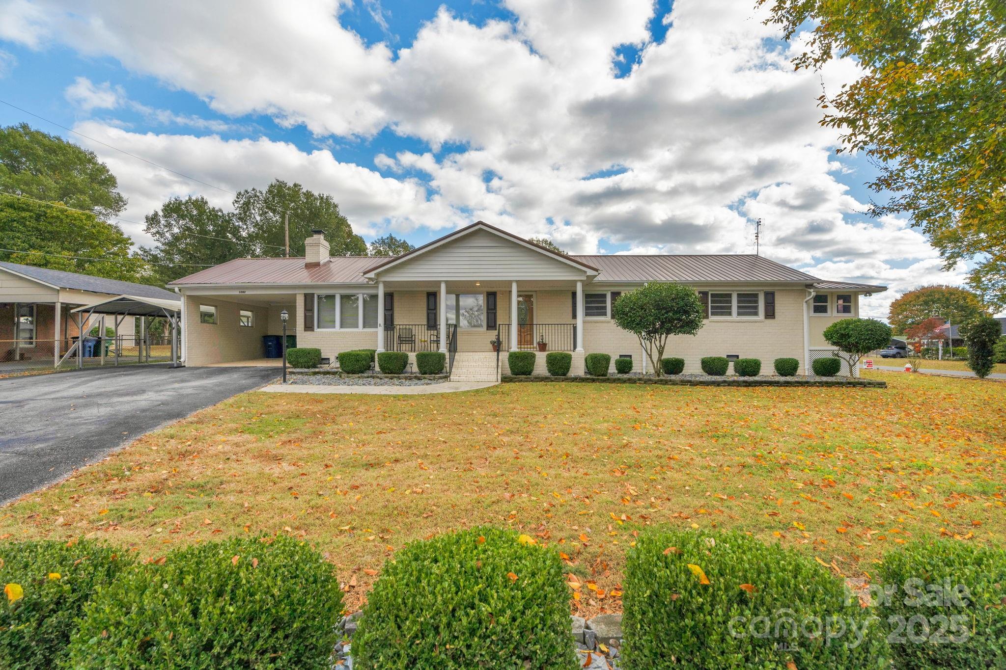 1202 Flowe Drive Matthews, NC 28104 - Photo 1 of 47 a front view of a house with yard and balcony