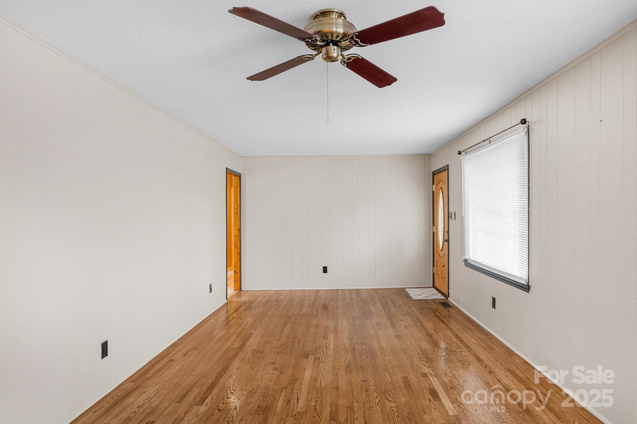 1202 Flowe Drive Matthews, NC 28104 - Photo 11 of 47 an empty room with a window and a ceiling fan