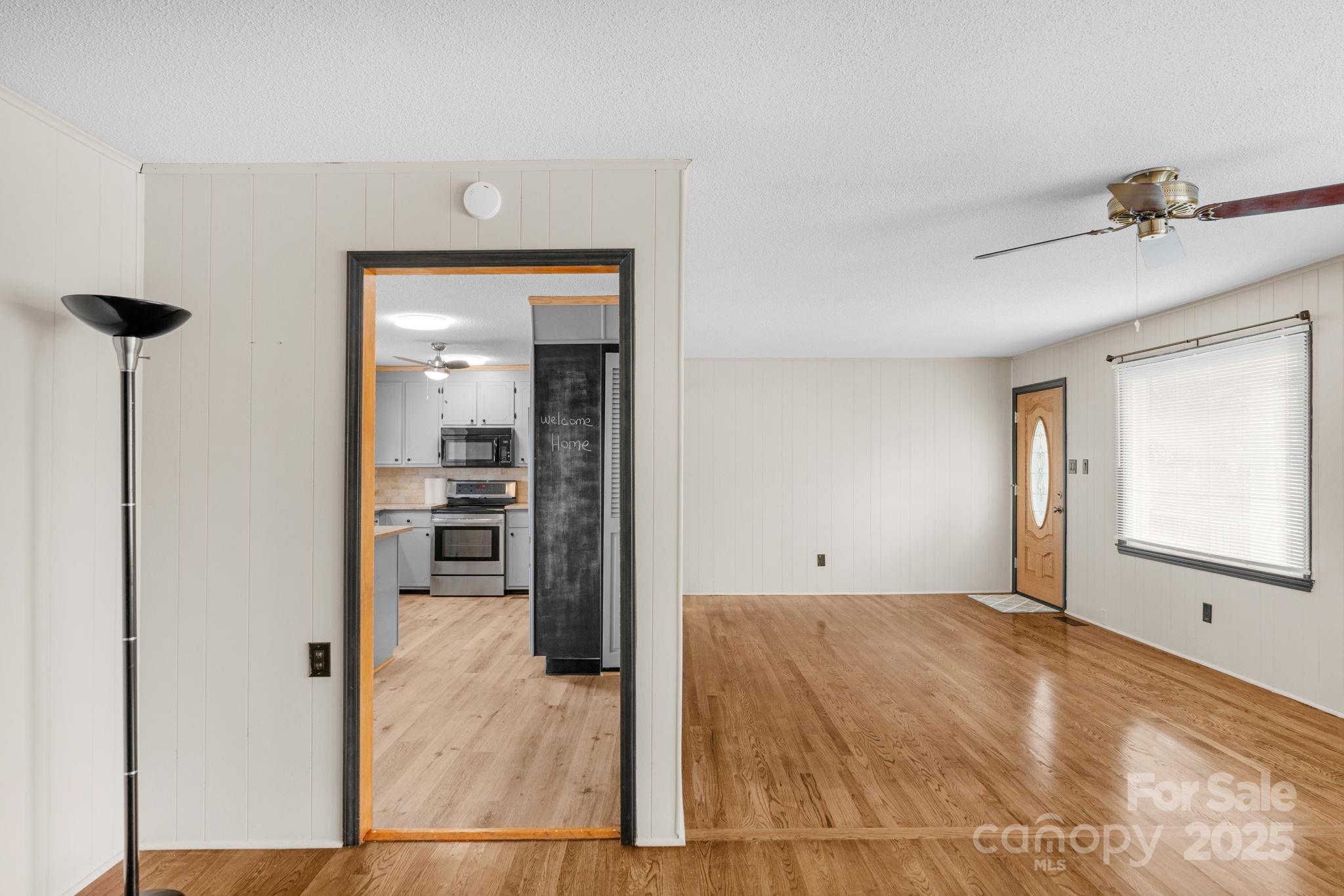 1202 Flowe Drive Matthews, NC 28104 - Photo 12 of 47 a view of a room with a stylish ceiling fan and entryway
