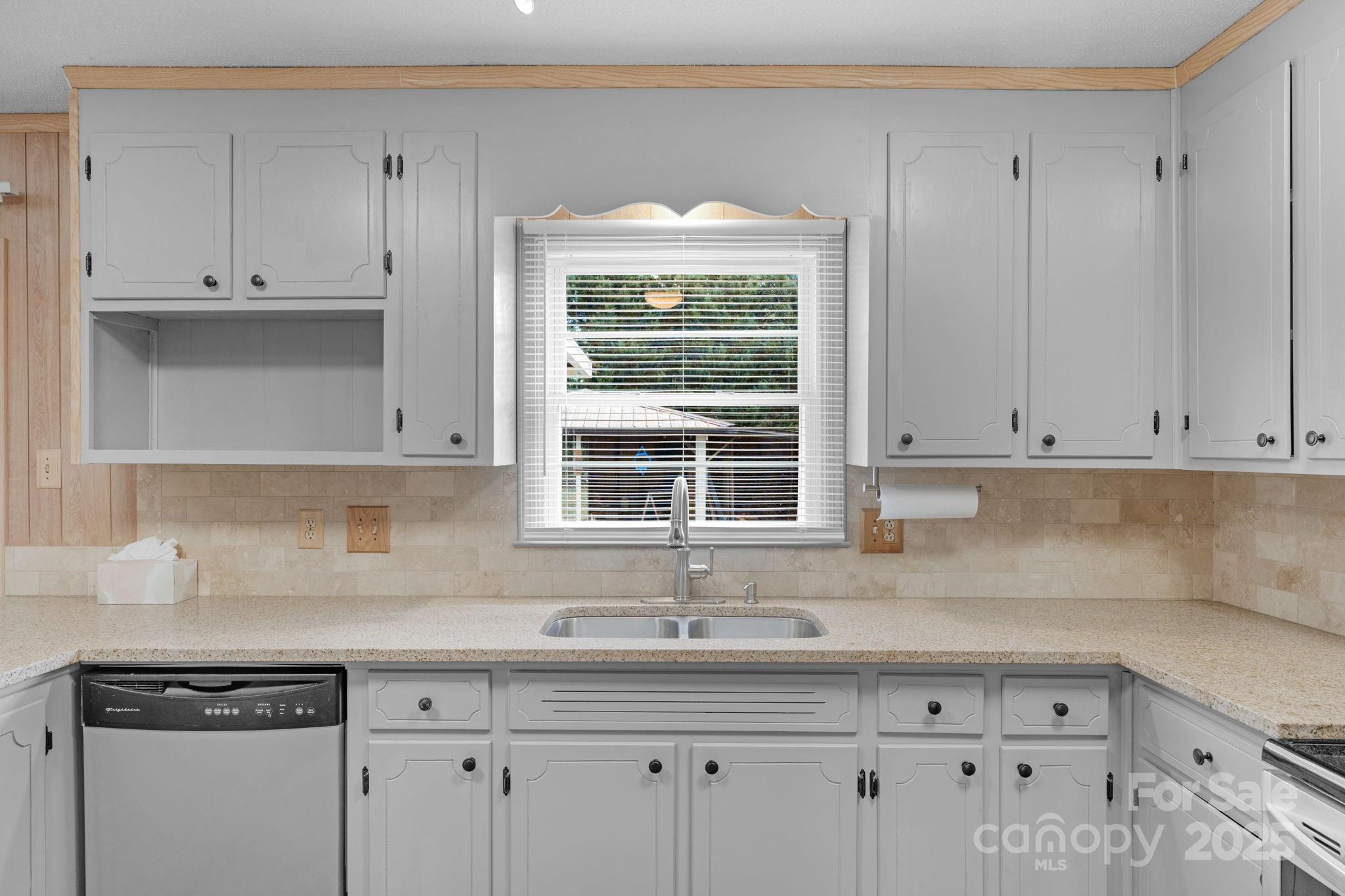 1202 Flowe Drive Matthews, NC 28104 - Photo 15 of 47 a kitchen with granite countertop white cabinets and a window