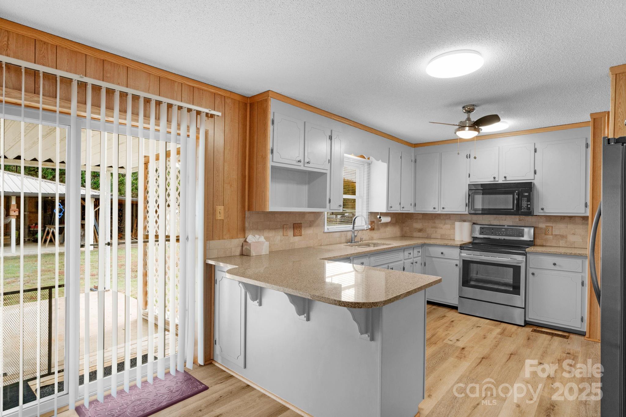 1202 Flowe Drive Matthews, NC 28104 - Photo 19 of 47 a kitchen with stainless steel appliances granite countertop a sink stove and cabinets