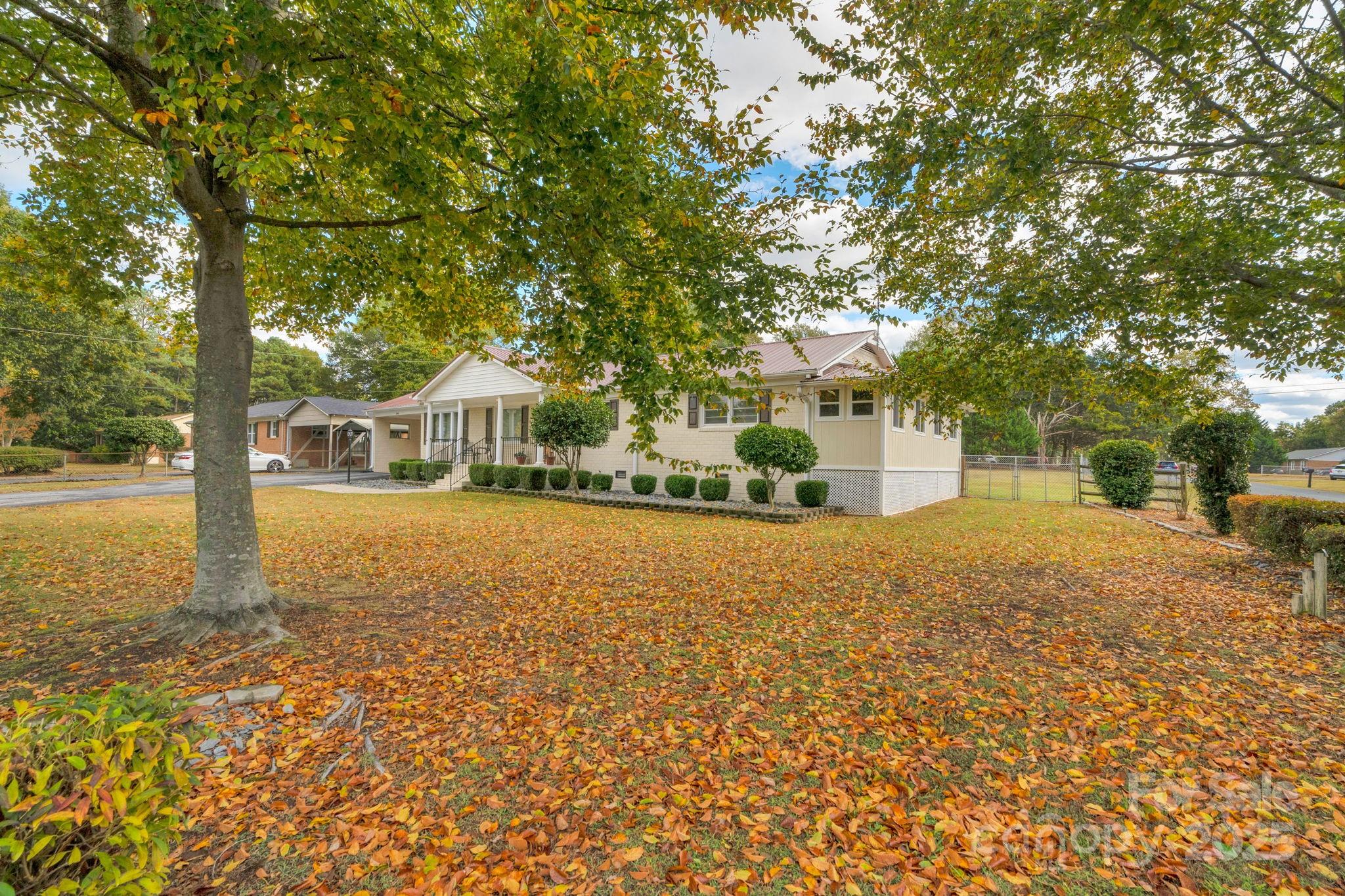 1202 Flowe Drive Matthews, NC 28104 - Photo 2 of 47 a front view of a house with a yard and trees