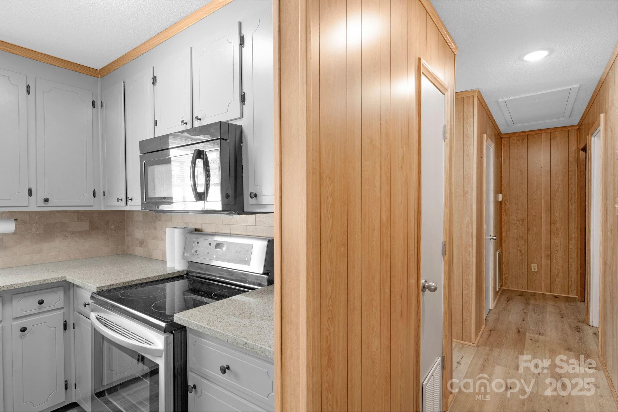 1202 Flowe Drive Matthews, NC 28104 - Photo 21 of 47 a kitchen with white cabinets and white appliances