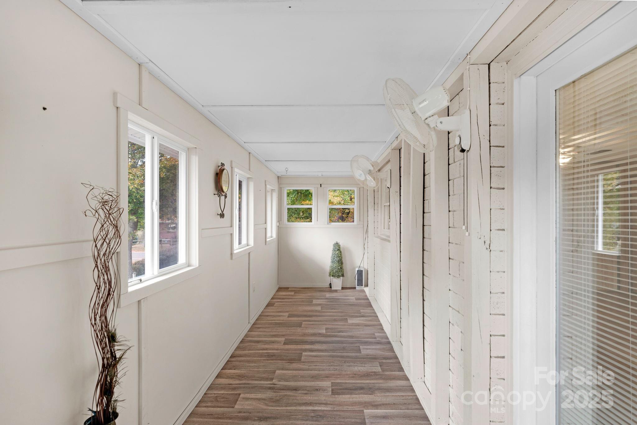 1202 Flowe Drive Matthews, NC 28104 - Photo 29 of 47 a view of a hallway with wooden floor and windows