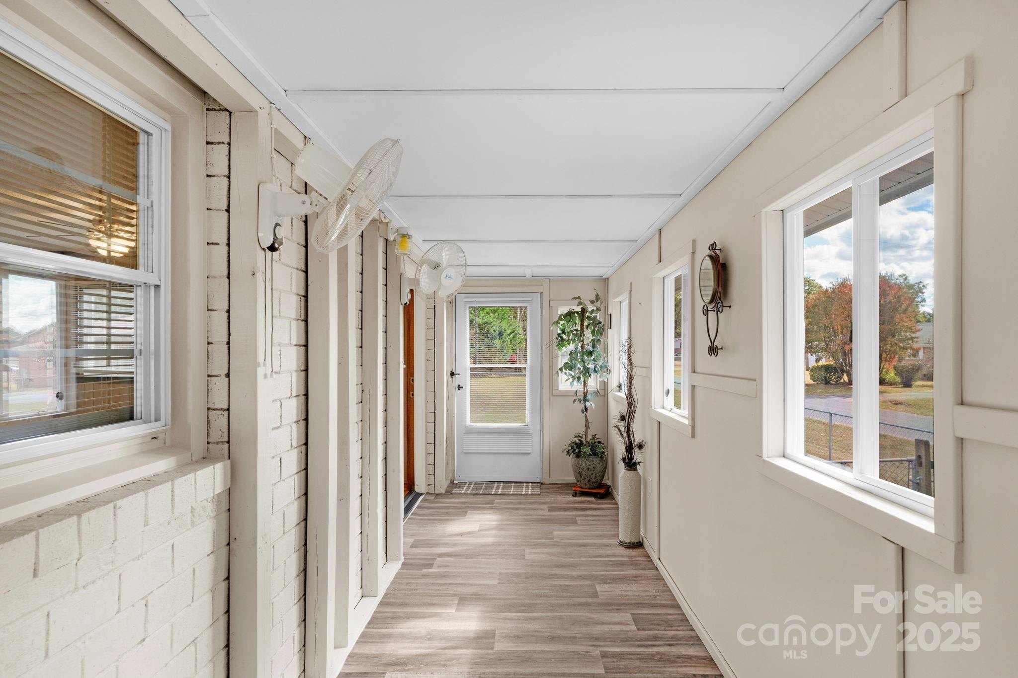 1202 Flowe Drive Matthews, NC 28104 - Photo 30 of 47 a view of a hallway with wooden floor and windows