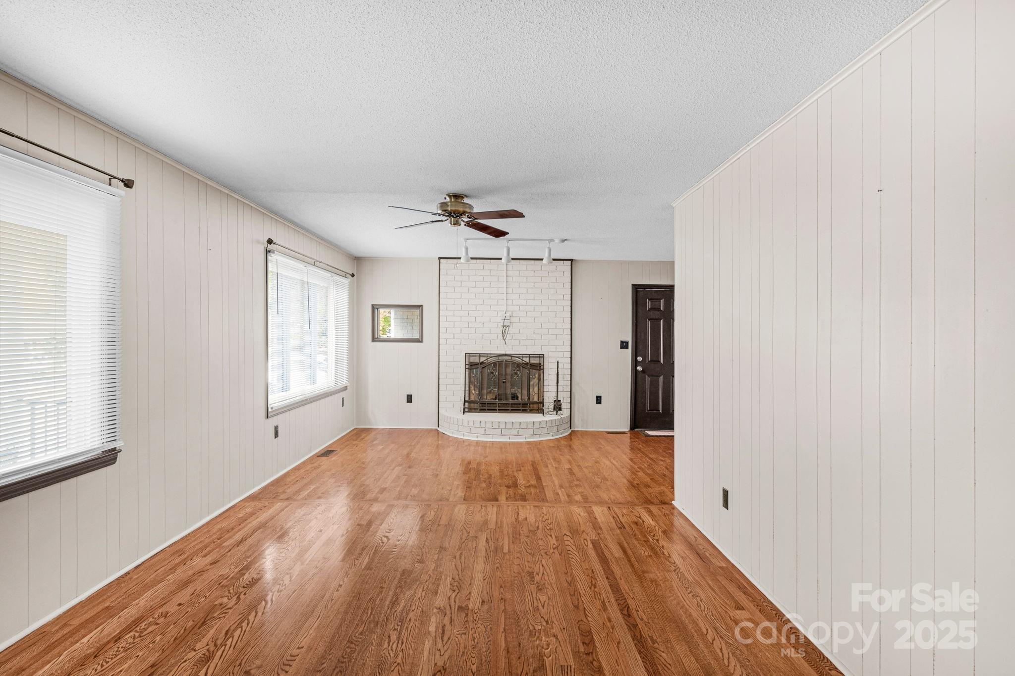 1202 Flowe Drive Matthews, NC 28104 - Photo 7 of 47 a view of an empty room with wooden floor and a window