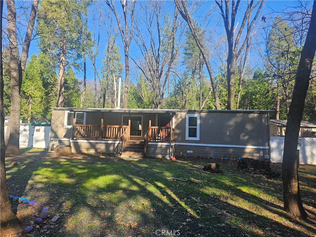 a view of house with backyard