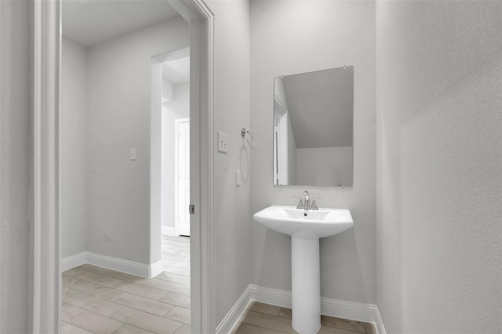 3112 Giovanni Point Princeton, TX 75407 - Photo 13 of 37 a bathroom with a sink and a mirror