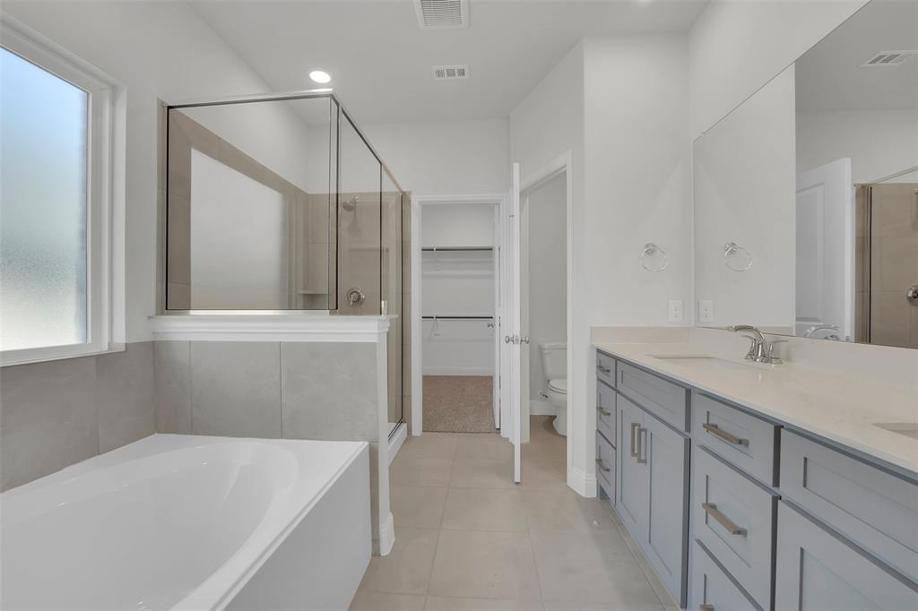 3112 Giovanni Point Princeton, TX 75407 - Photo 21 of 37 a bathroom with a tub sink and mirror