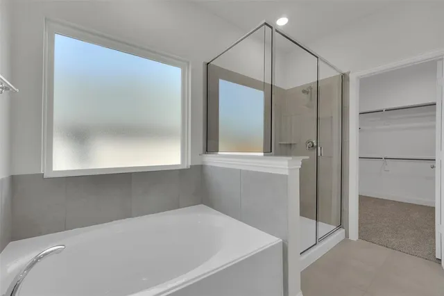 a bathroom with a bathtub and a shower