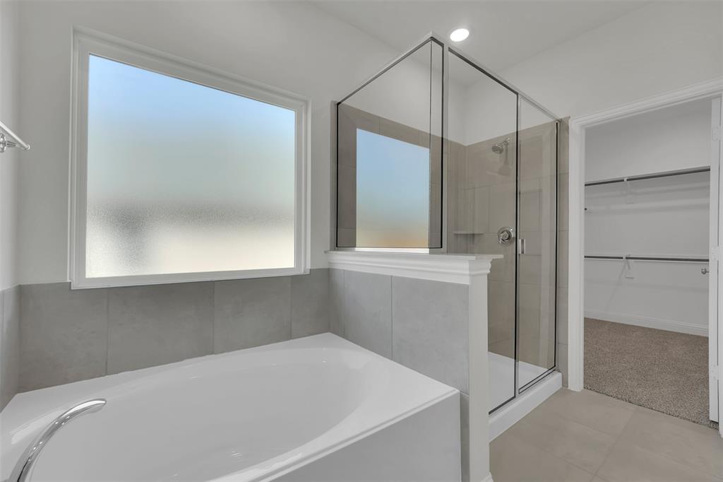 3112 Giovanni Point Princeton, TX 75407 - Photo 23 of 37 a bathroom with a bathtub and a shower