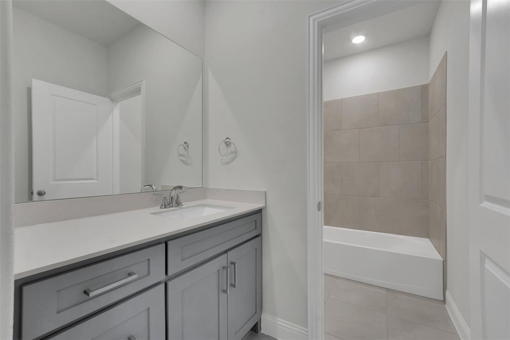 3112 Giovanni Point Princeton, TX 75407 - Photo 33 of 37 a bathroom with a granite countertop sink and a mirror