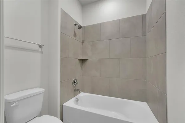 a bathroom with a bathtub and toilet