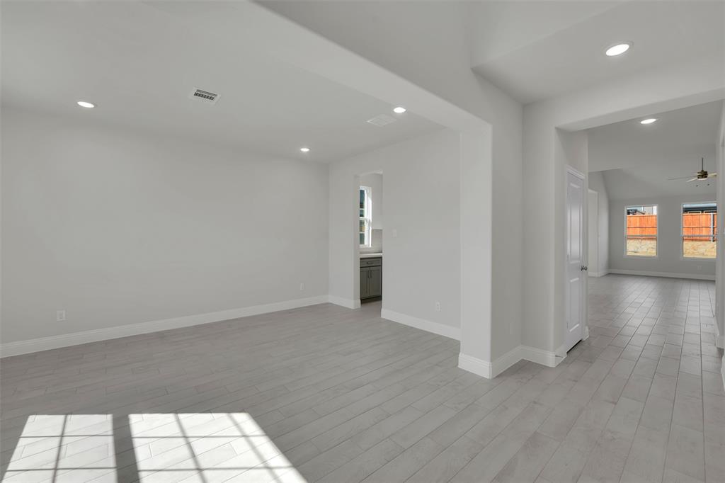 3112 Giovanni Point Princeton, TX 75407 - Photo 5 of 37 wooden floor in an empty room with a window