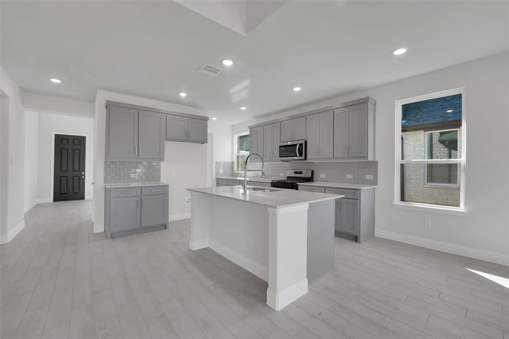 3112 Giovanni Point Princeton, TX 75407 - Photo 7 of 37 a kitchen with white cabinets and window