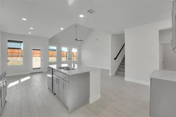 a kitchen with stainless steel appliances granite countertop a stove and a refrigerator