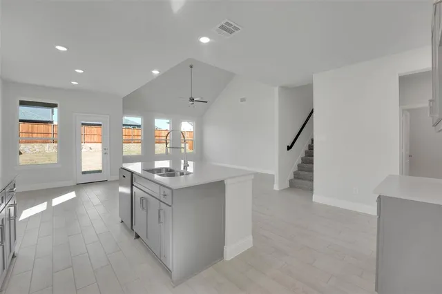 a kitchen with stainless steel appliances granite countertop a stove and a refrigerator