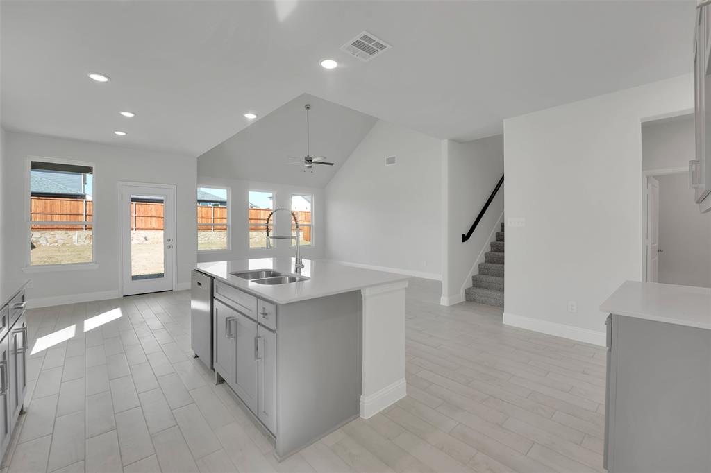 3112 Giovanni Point Princeton, TX 75407 - Photo 9 of 37 a kitchen with stainless steel appliances granite countertop a stove and a refrigerator