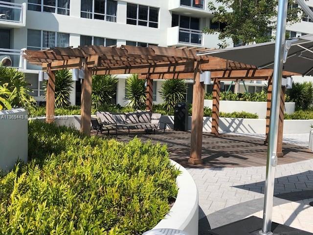 1500 Bay Road, Unit 958S Miami Beach, FL 33139 - Photo 12 of 20 a view of a patio with table and chairs potted plants