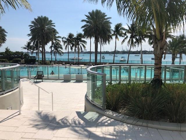 1500 Bay Road, Unit 958S Miami Beach, FL 33139 - Photo 16 of 20 a view of a swimming pool with a patio and a garden