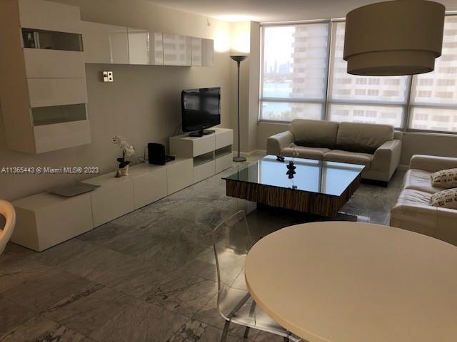 1500 Bay Road, Unit 958S Miami Beach, FL 33139 - Photo 3 of 20 a living room with furniture and a flat screen tv