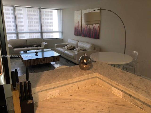 1500 Bay Road, Unit 958S Miami Beach, FL 33139 - Photo 4 of 20 a living room with a couch and a table