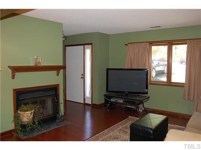 7611 Ladden Court Raleigh, NC 27615 - Photo 4 of 15 a living room with furniture and a fireplace